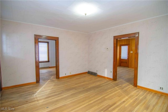 unfurnished room with hardwood / wood-style flooring and ornamental molding