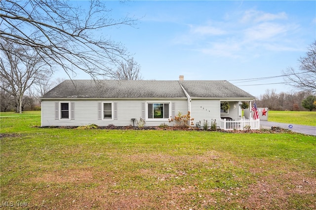 back of property featuring a lawn and a porch