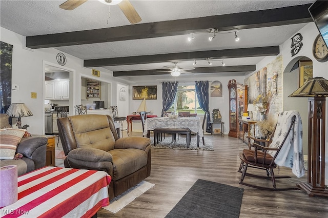 living room with dark hardwood / wood-style floors, beam ceiling, and a textured ceiling