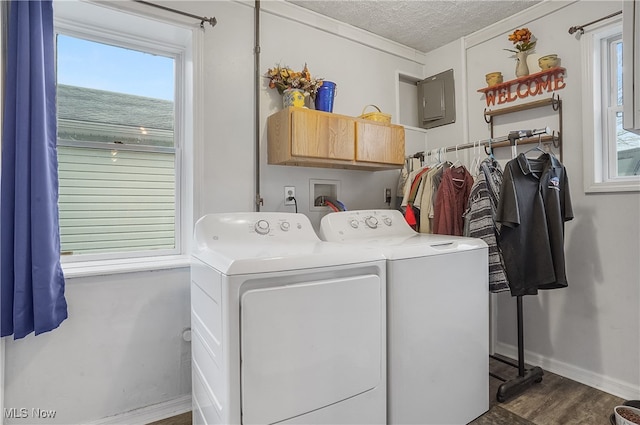 clothes washing area featuring washing machine and clothes dryer, cabinets, dark wood-type flooring, and a textured ceiling