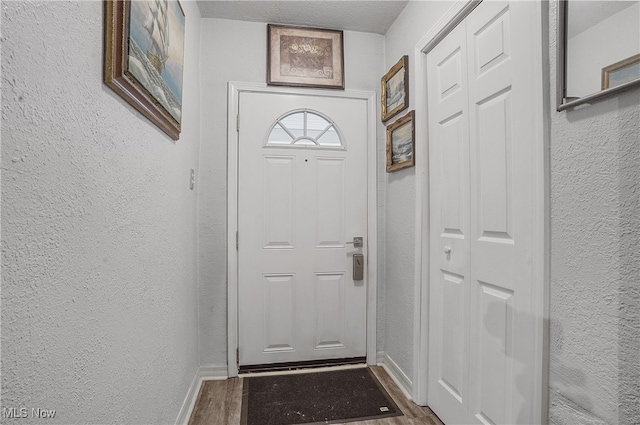 doorway to outside with hardwood / wood-style flooring