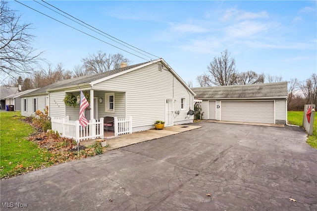 view of property exterior with an outbuilding, a garage, and covered porch