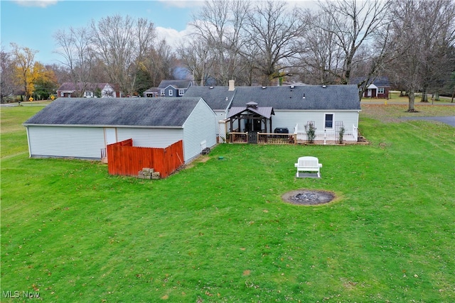 rear view of property with a gazebo and a yard