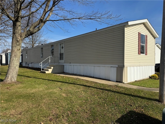 rear view of property with a lawn