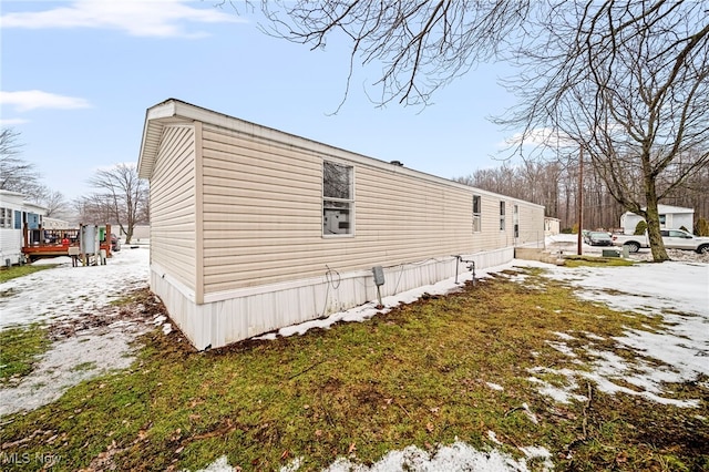 snow covered property with a lawn