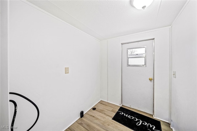 entrance foyer with a textured ceiling and light wood-type flooring