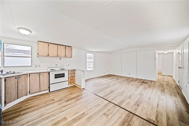 kitchen featuring white range with electric stovetop, lofted ceiling, sink, light hardwood / wood-style floors, and a textured ceiling