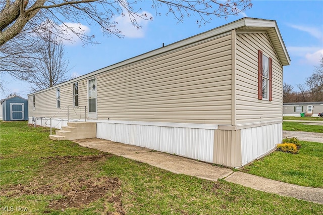 3583 Austin Dr Unit 94, Geneva, OH 44041 - view of property exterior with an outdoor structure, a storage unit, and a lawn