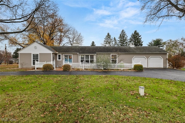 single story home featuring a front yard and a garage