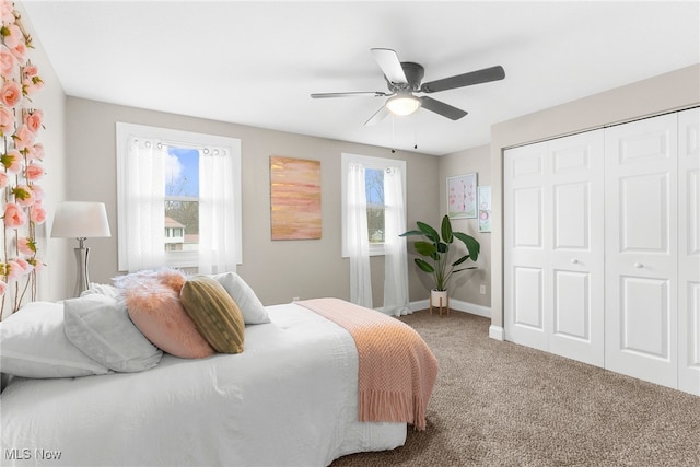 carpeted bedroom with multiple windows, a closet, and ceiling fan