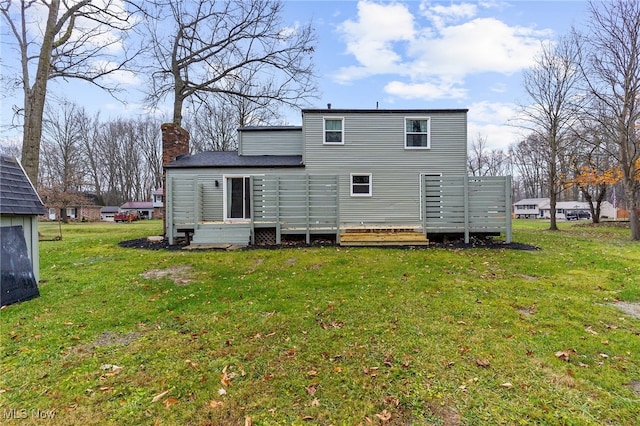 rear view of house with a yard