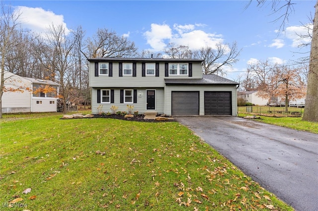 front of property featuring a front yard and a garage