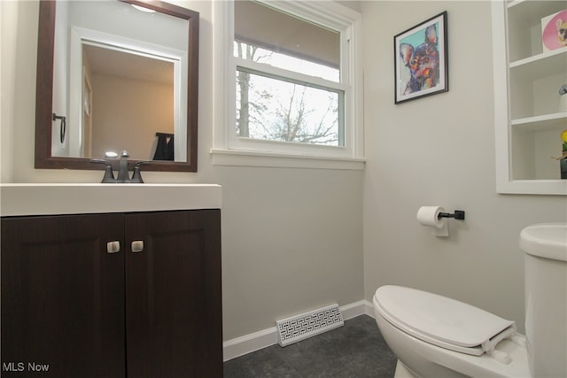 bathroom with tile patterned flooring, vanity, and toilet