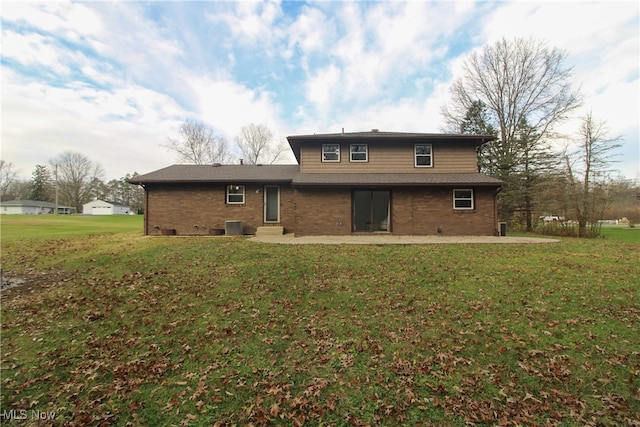 back of house featuring a lawn, a patio area, and central air condition unit