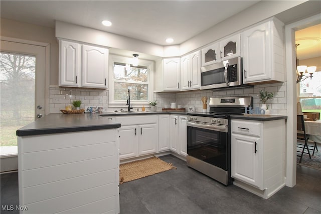 kitchen featuring stainless steel appliances, white cabinetry, and a healthy amount of sunlight