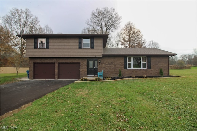 view of front of property with a front yard and a garage