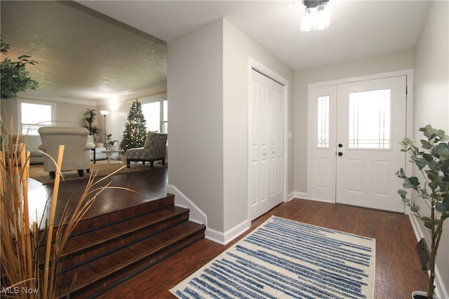 foyer entrance featuring dark hardwood / wood-style floors and a textured ceiling