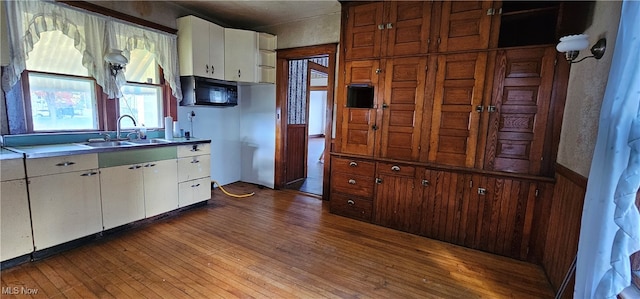 kitchen featuring white cabinets, dark hardwood / wood-style flooring, and sink