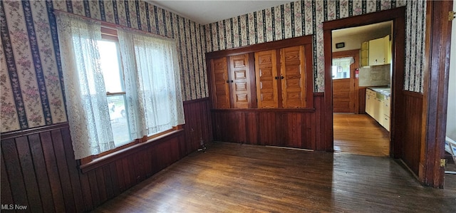 interior space featuring dark hardwood / wood-style floors and wood walls