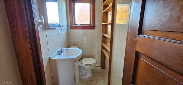 bathroom featuring tile patterned flooring, vanity, tile walls, and toilet