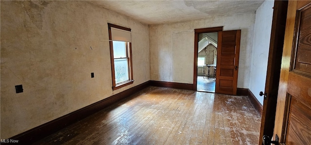 spare room with dark hardwood / wood-style flooring