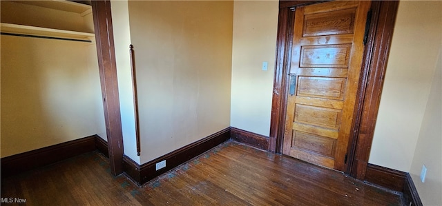 unfurnished bedroom featuring dark wood-type flooring