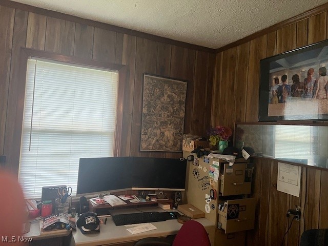 office space with wood walls and a textured ceiling