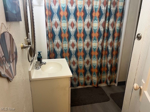 bathroom with hardwood / wood-style floors and vanity