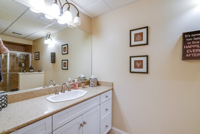 bathroom featuring vanity and a shower with door