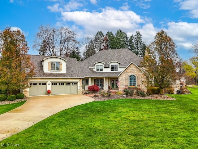 view of front of property featuring a front lawn and a garage