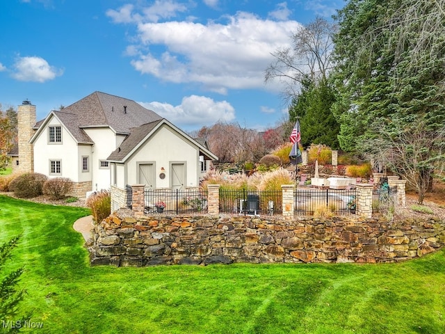 back of house with a lawn