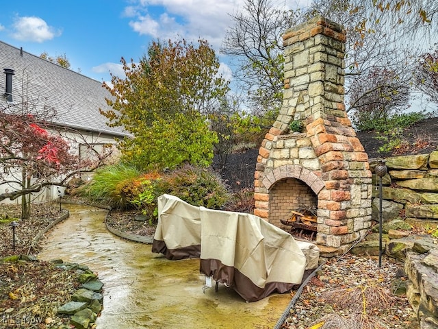 view of patio / terrace with an outdoor stone fireplace