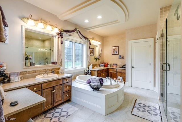 bathroom featuring tile patterned floors, vanity, and shower with separate bathtub