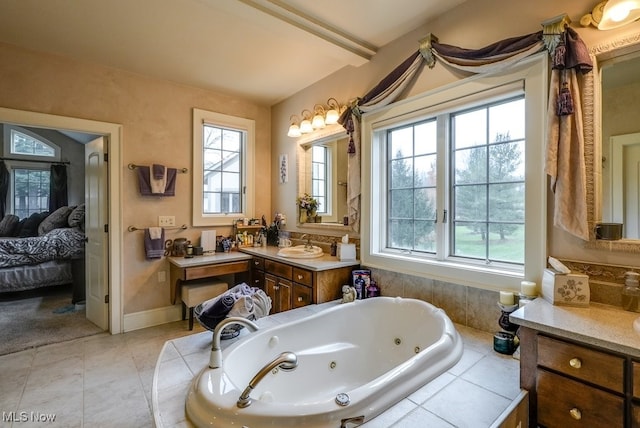 bathroom with tile patterned floors, vanity, lofted ceiling, and tiled tub