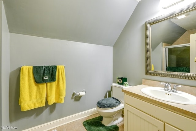 bathroom with tile patterned floors, lofted ceiling, toilet, vanity, and a shower with shower door