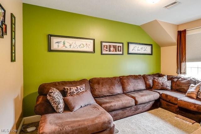 living room featuring carpet and vaulted ceiling