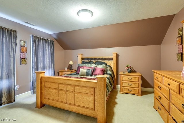 carpeted bedroom with a textured ceiling and lofted ceiling