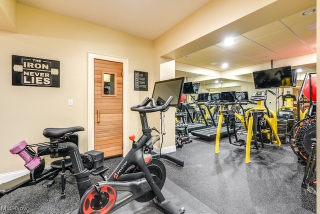 exercise room with a paneled ceiling