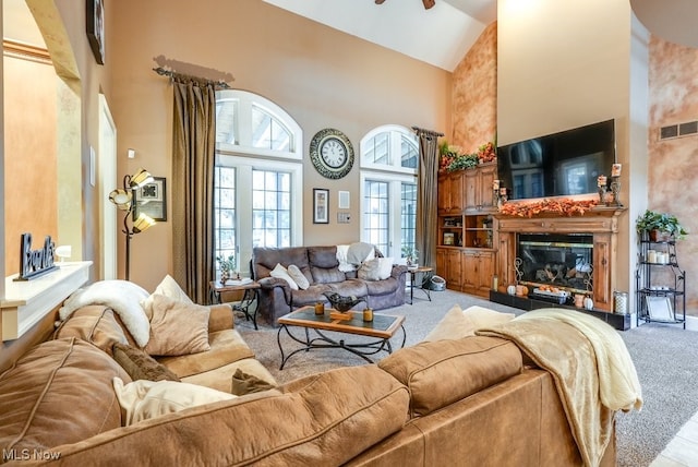 living room featuring carpet flooring, high vaulted ceiling, and ceiling fan