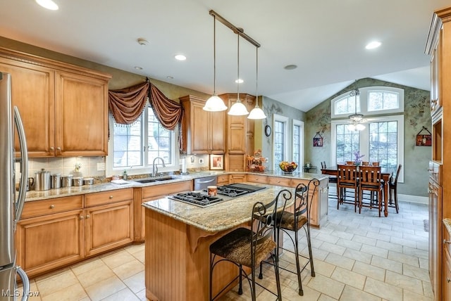 kitchen featuring plenty of natural light, a kitchen island, lofted ceiling, and sink