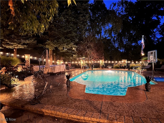 view of pool at night