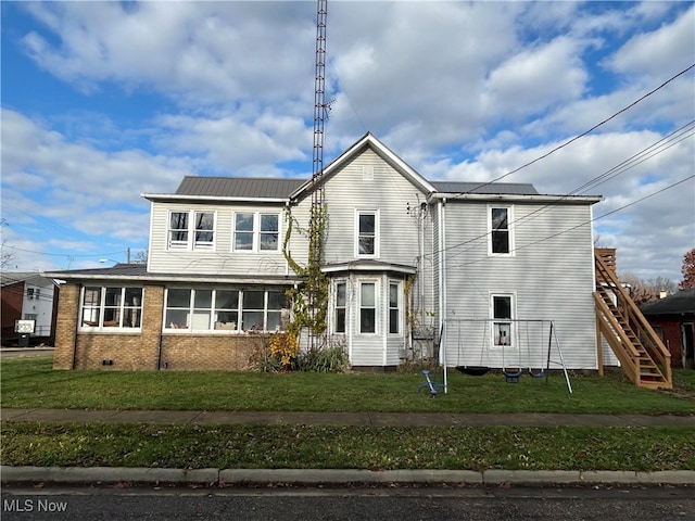 exterior space featuring a sunroom and a yard