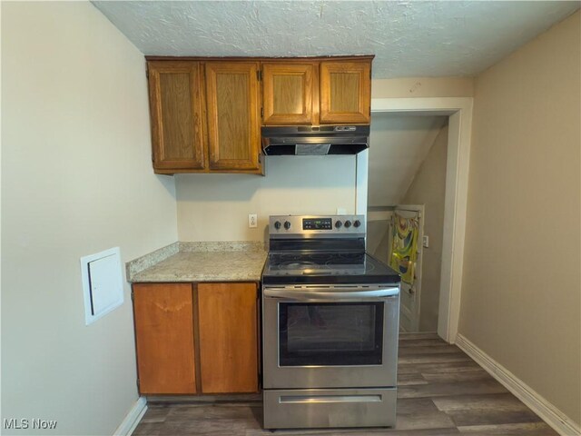 kitchen with stainless steel range with electric cooktop, dark wood-type flooring, and a textured ceiling