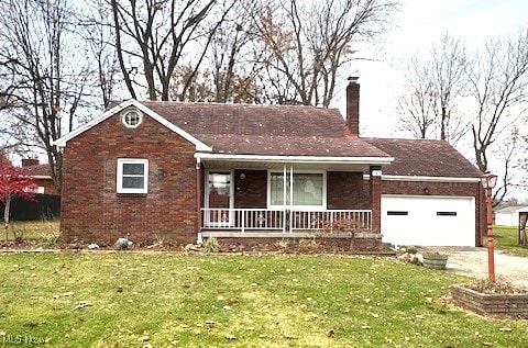 single story home with a porch, a garage, and a front lawn