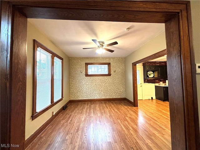 unfurnished room with ceiling fan and hardwood / wood-style floors