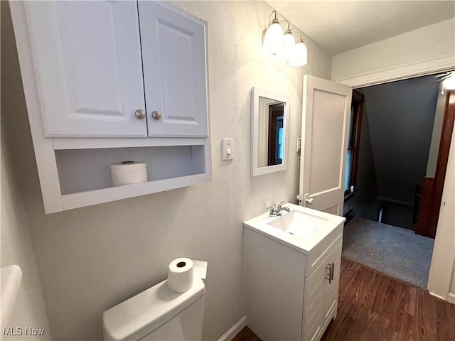 bathroom with vanity, hardwood / wood-style floors, and toilet