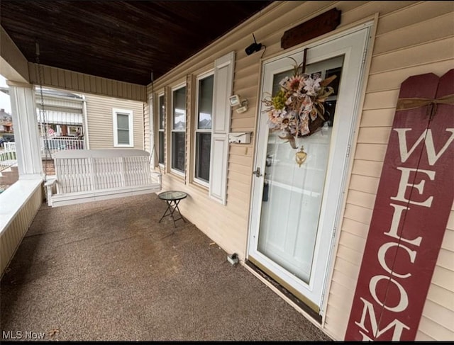 doorway to property featuring a porch