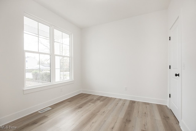 unfurnished room featuring a healthy amount of sunlight and light hardwood / wood-style flooring