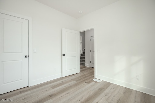 unfurnished bedroom featuring light wood-type flooring