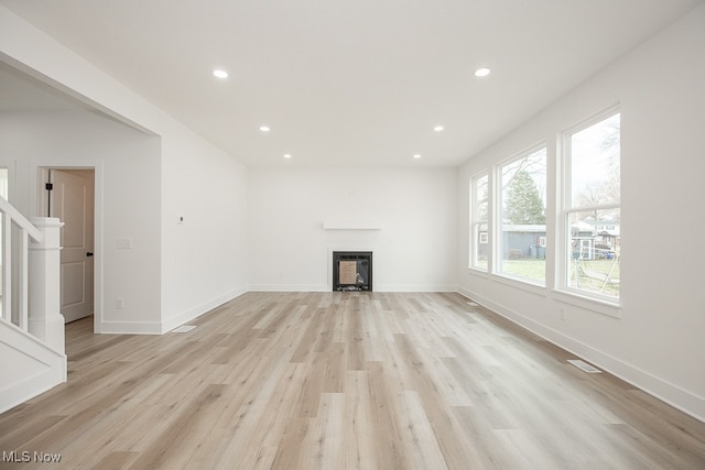 unfurnished living room with light hardwood / wood-style floors